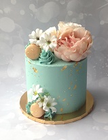 Teal green buttercream cake with faux flowrs